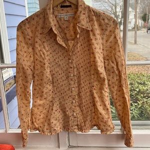 Shirt with front stitching and eyelet detail around collar.